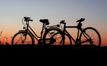 2 bicycles parked during sunset